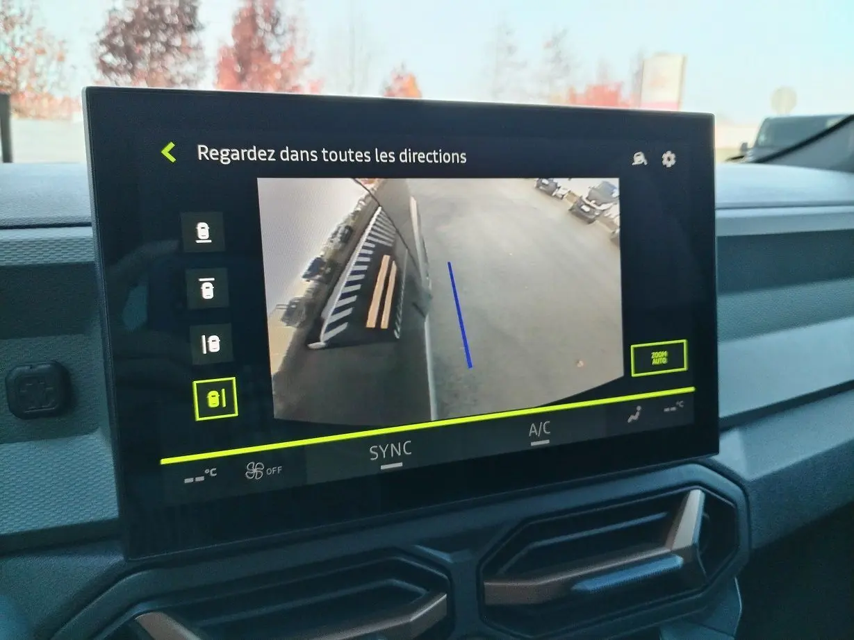 Écran central du Dacia Bigster noir 2025 montrant la caméra 360° avec vue latérale droite du véhicule en stationnement.