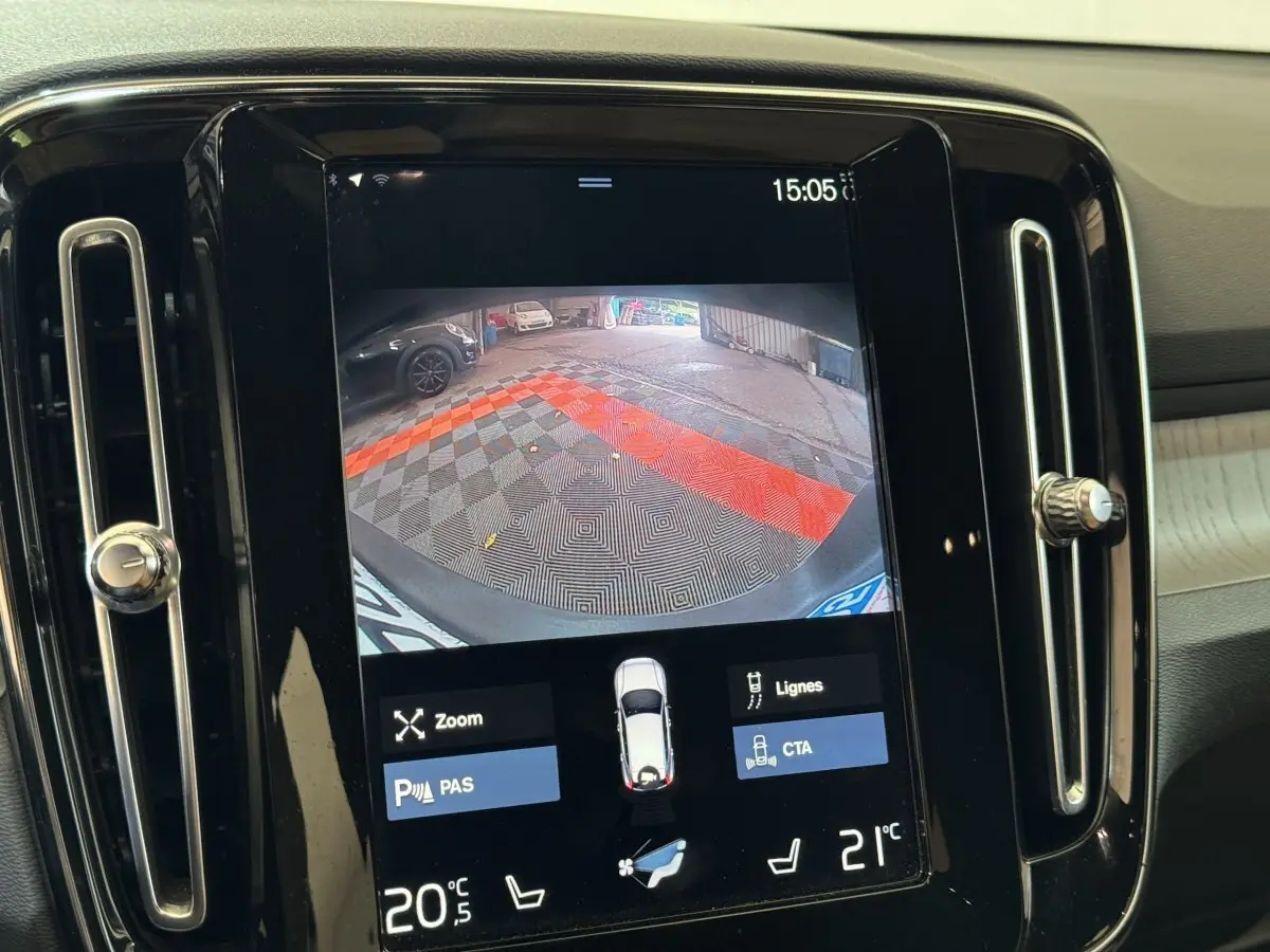 Écran tactile central du Volvo XC40 Recharge T5 montrant la caméra de recul avec aides au stationnement activées.