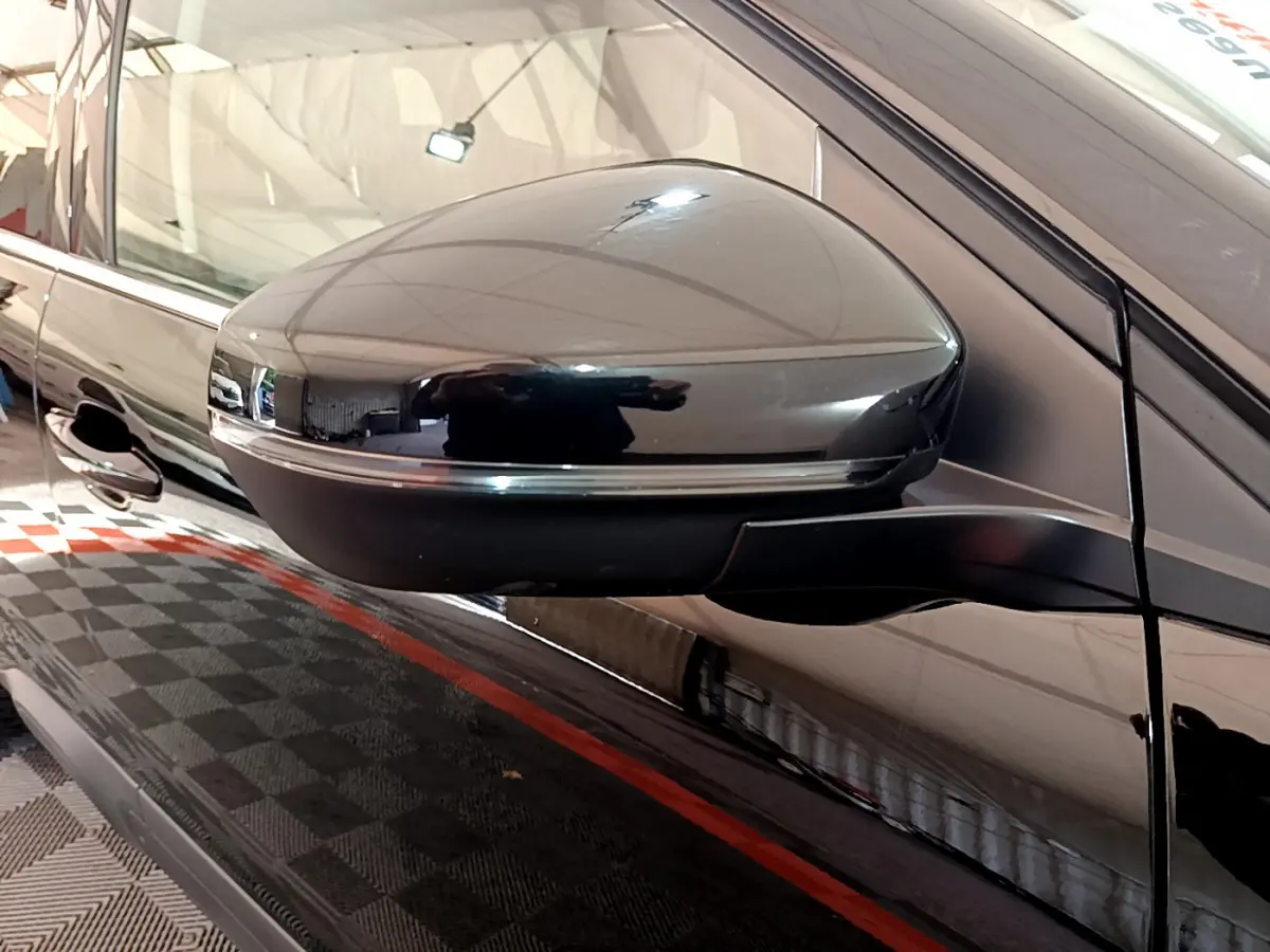 Rétroviseur droit noir brillant du Citroën C5 Aircross Hybrid 225 ë-EAT8 Shine, reflet sur carrosserie noire.