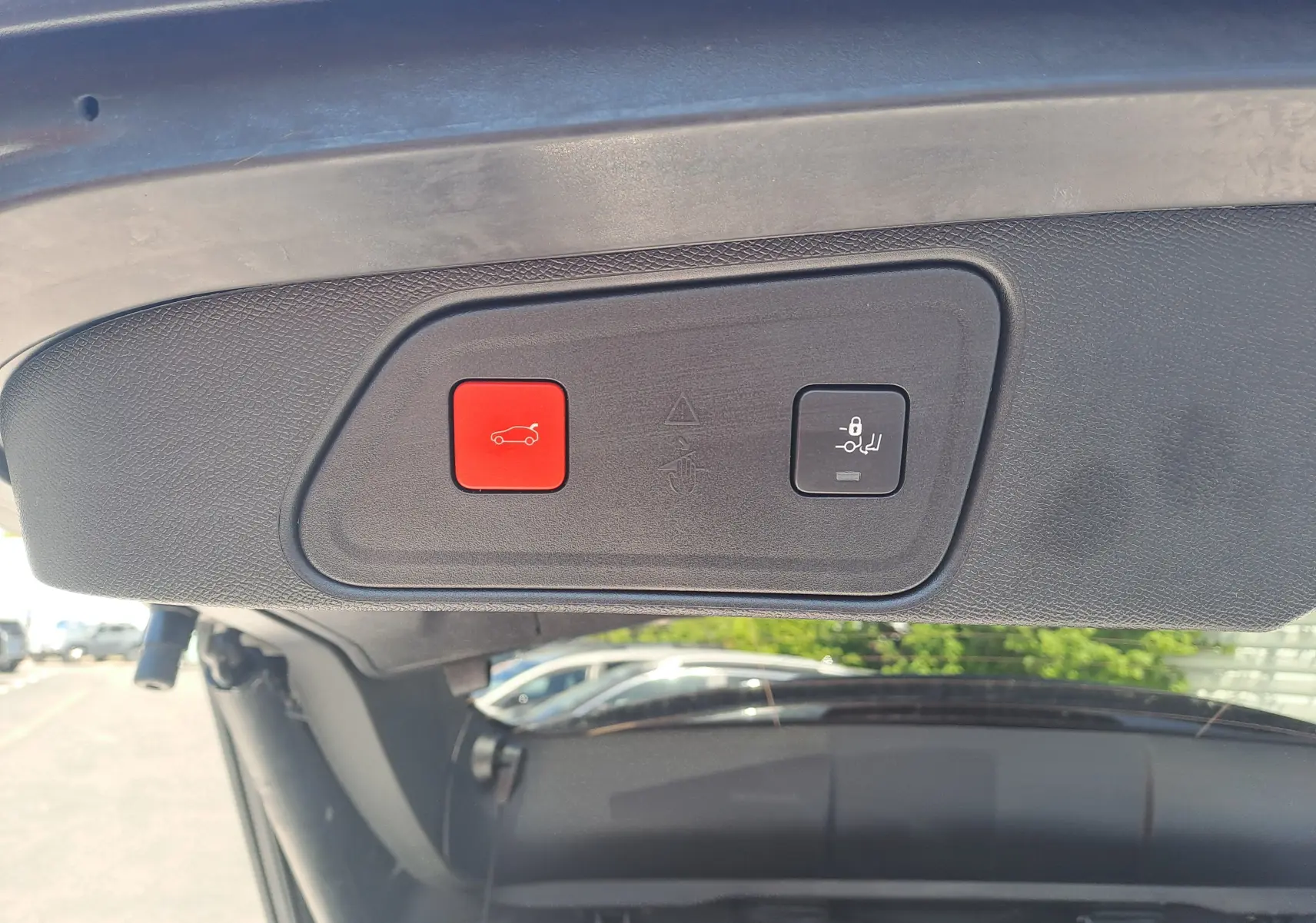 Gros plan sur les boutons d'ouverture et fermeture électrique du coffre du Peugeot 3008 blanc nacré, vue intérieure du hayon.