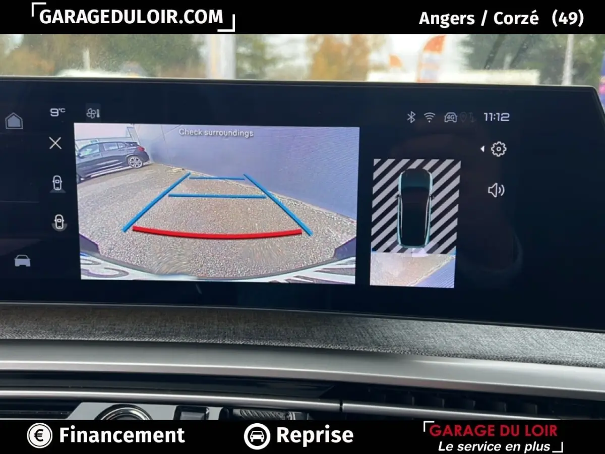Écran intérieur du Peugeot 5008 hybride 2024 montrant la caméra de recul avec vue arrière et top-down en bleu.