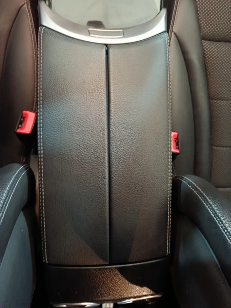 Vue rapprochée de l'accoudoir central en cuir noir avec surpiqûres blanches du Mercedes GLC 300 E Business Line 2021.