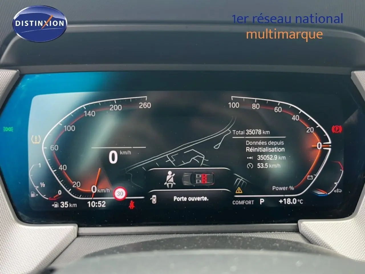 Écran tactile du système iDrive de la BMW Série 1 116i 2022, affichant les réglages de conduite et d’éclairage.