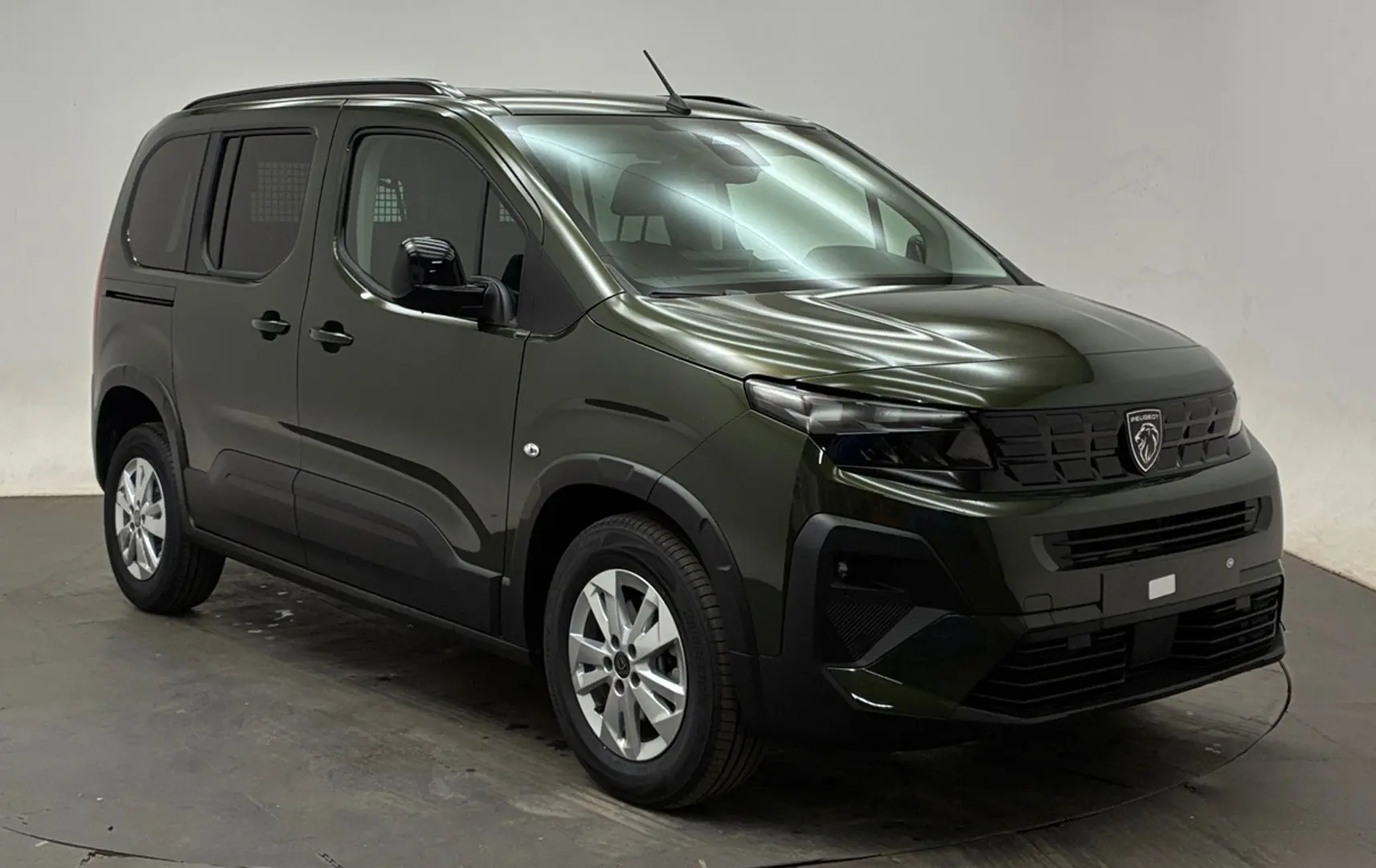 PEUGEOT RIFTER Sirkka Green en vue 3/4 avant droit, avec jantes alliage et barres de toit noir mat.