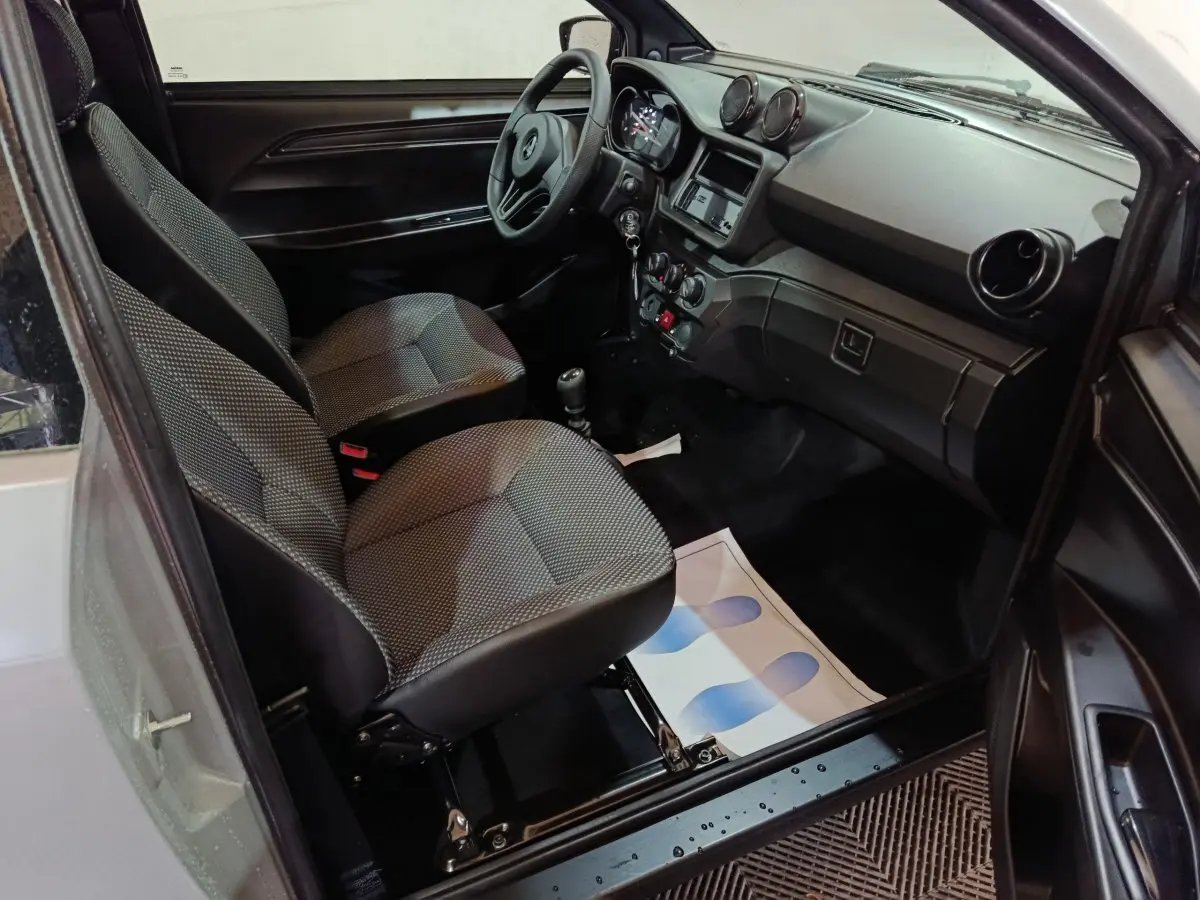 Vue intérieure côté conducteur de l'AIXAM AMBITION 0.5 CITY PACK 2026, sièges gris et tableau de bord noir.