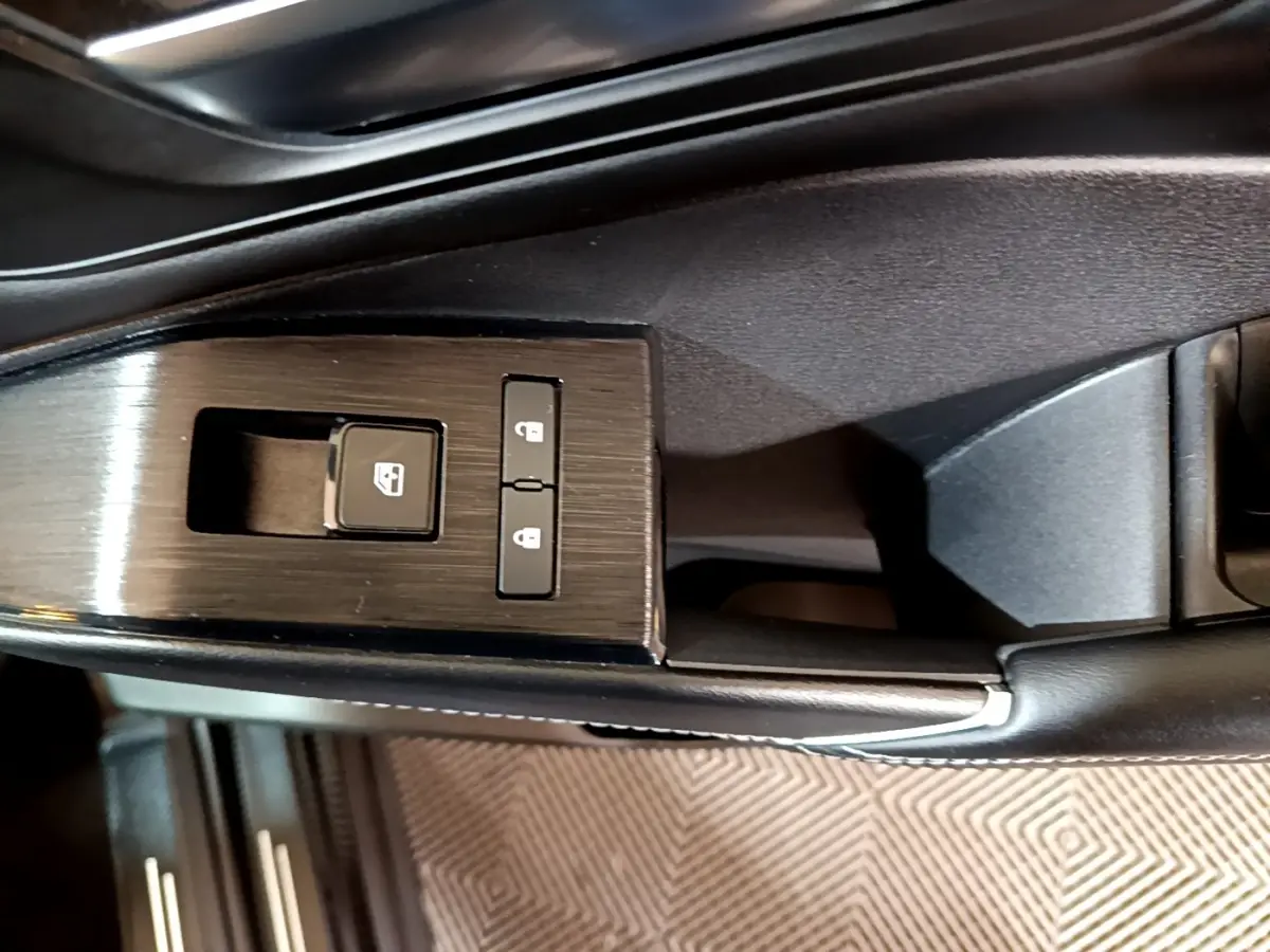 Gros plan sur les commandes de verrouillage et lève-vitre côté conducteur du Nissan Qashqai e-Power noir, finition N-Connecta.