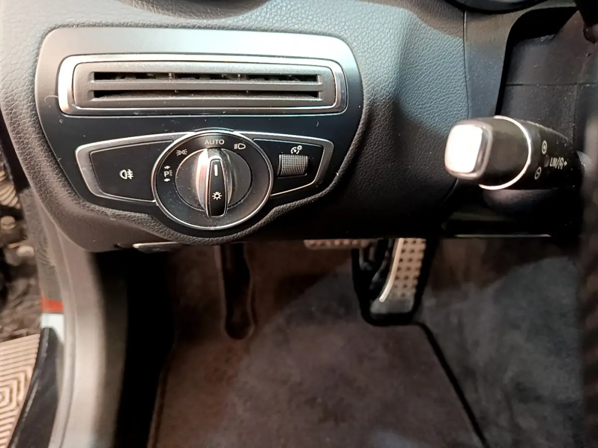 Gros plan sur le tableau de bord noir de la Mercedes Classe C Coupé 2018, avec commande d'éclairage et ventilation.