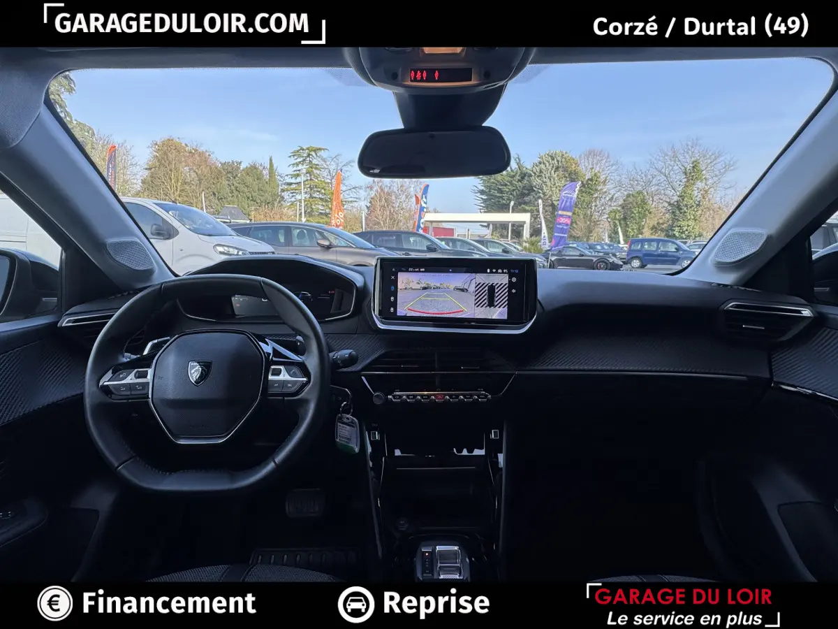 Intérieur noir de la Peugeot 208 Hybrid 110 e-DCS6 Allure 2025, vue frontale sur le tableau de bord et écran tactile central.