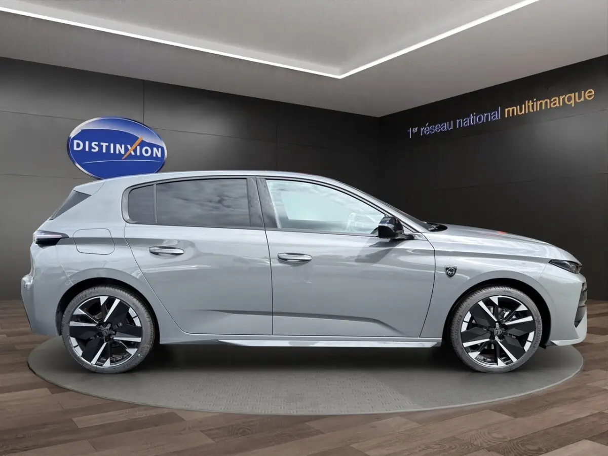 Vue de profil droit d'une Peugeot 308 gris clair 2026 avec jantes noires et détails modernes.