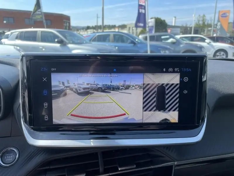 Affichage de la caméra de recul et vue 360° sur l'écran intérieur du Peugeot 2008 gris métal, tableau de bord visible.