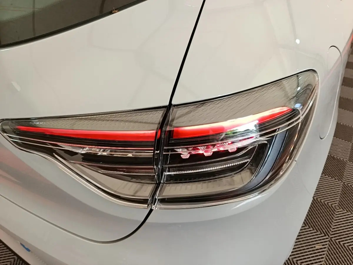 Gros plan sur le feu arrière droit rouge et noir d’une Renault Clio gris clair, version Evolution dCi 100 -25, 2025.