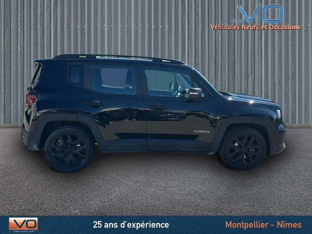 Vue de profil côté gauche d'un Jeep Renegade noir 2024 avec jantes alliage noires et barres de toit visibles.