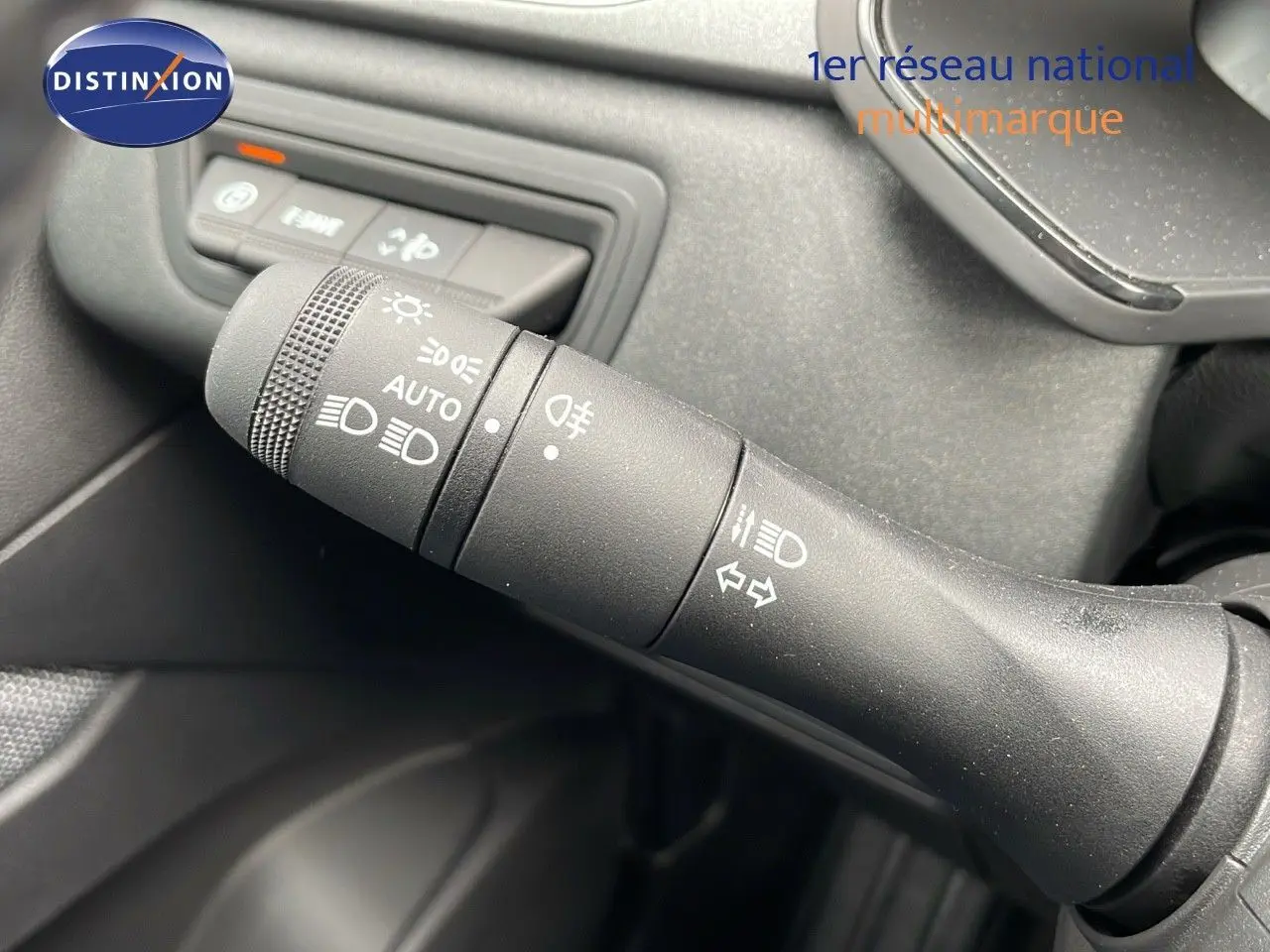 Gros plan sur la commande des feux et clignotants du Renault Captur E-Tech hybride, intérieur noir.