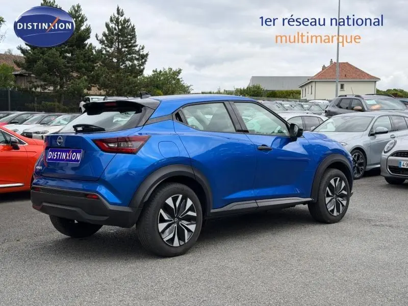 Vue 3/4 arrière droite du Nissan Juke 2025 bleu magnétique avec jantes distinctives et toit noir contrasté.