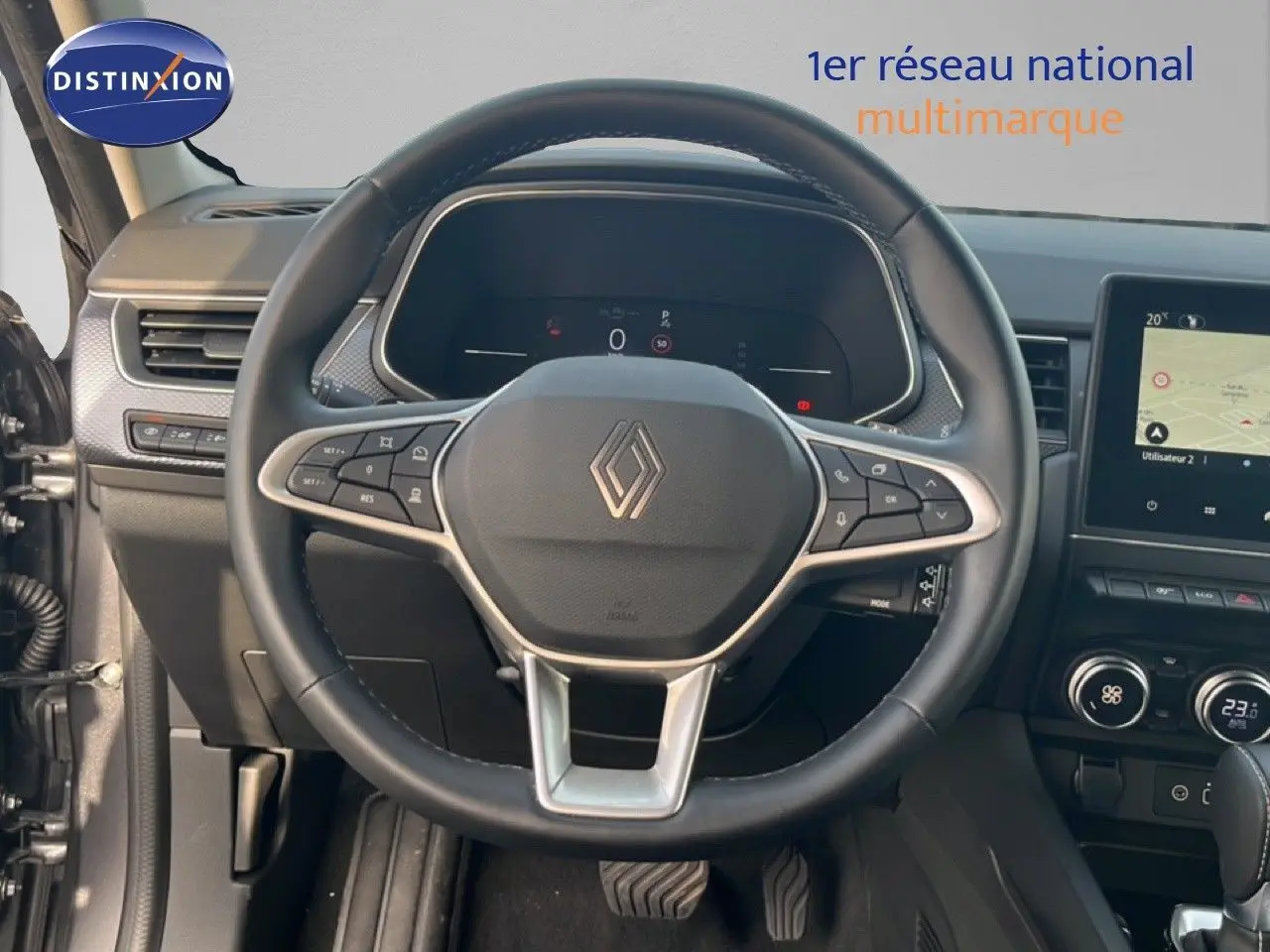 Vue intérieure centrée sur le volant du Renault Arkana 2025, avec tableau de bord numérique et écran tactile visible.