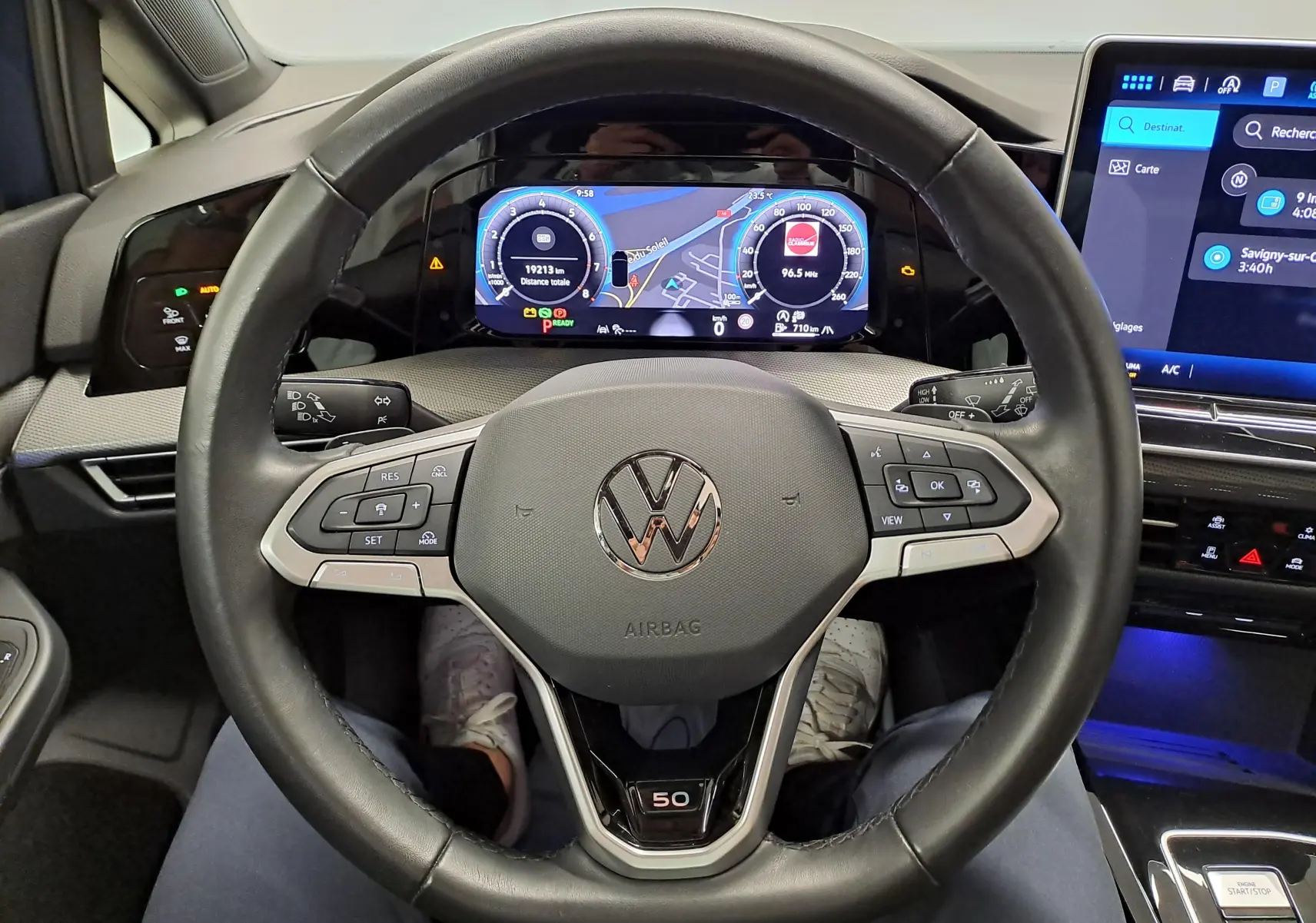 Vue intérieure centrée sur le volant Volkswagen Golf 1.5 eTSI Edition 50 avec tableau de bord numérique et badge 50.