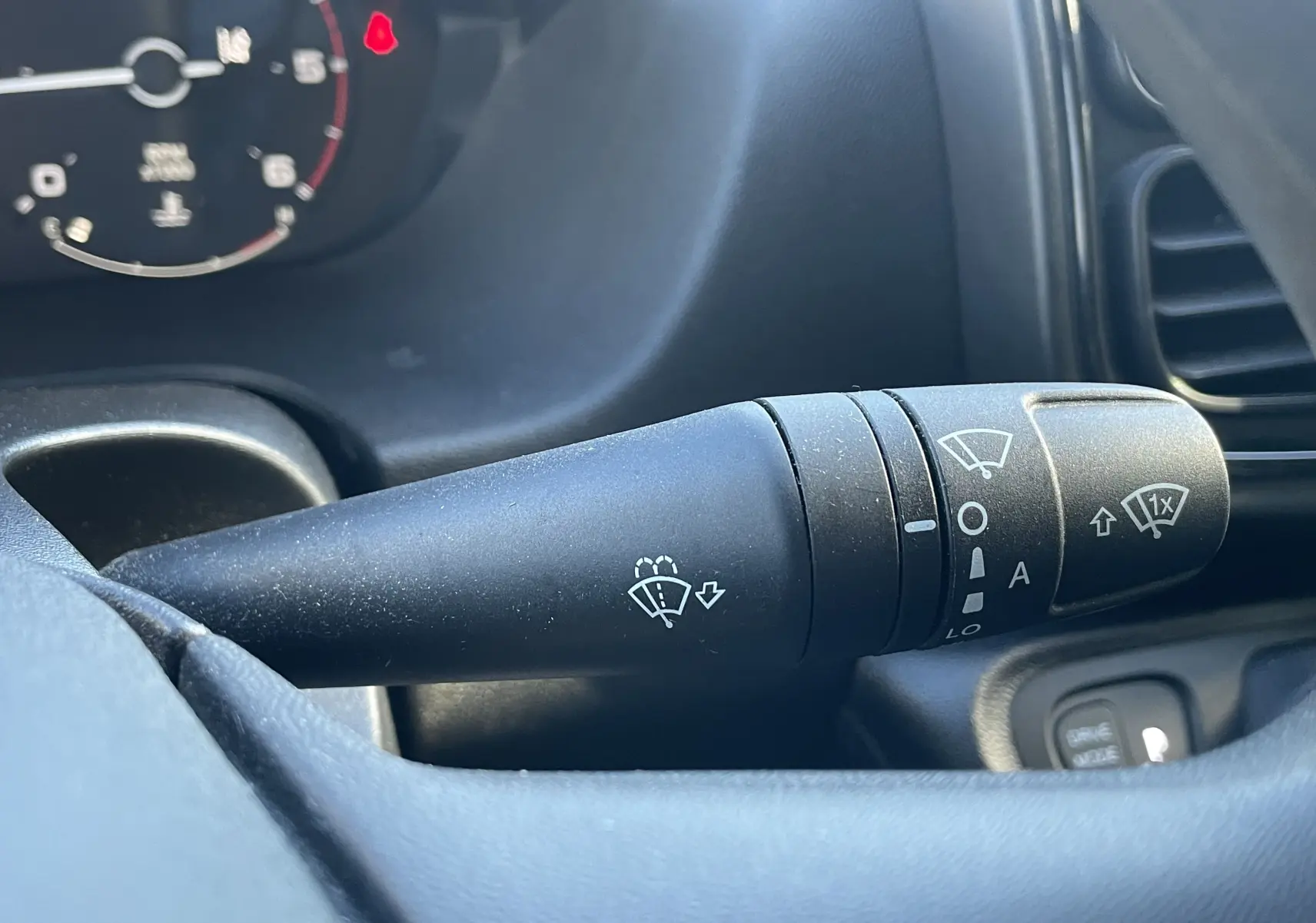 Gros plan sur la commande d’essuie-glace du Peugeot Boxer Fourgon blanc, vue intérieure côté conducteur.