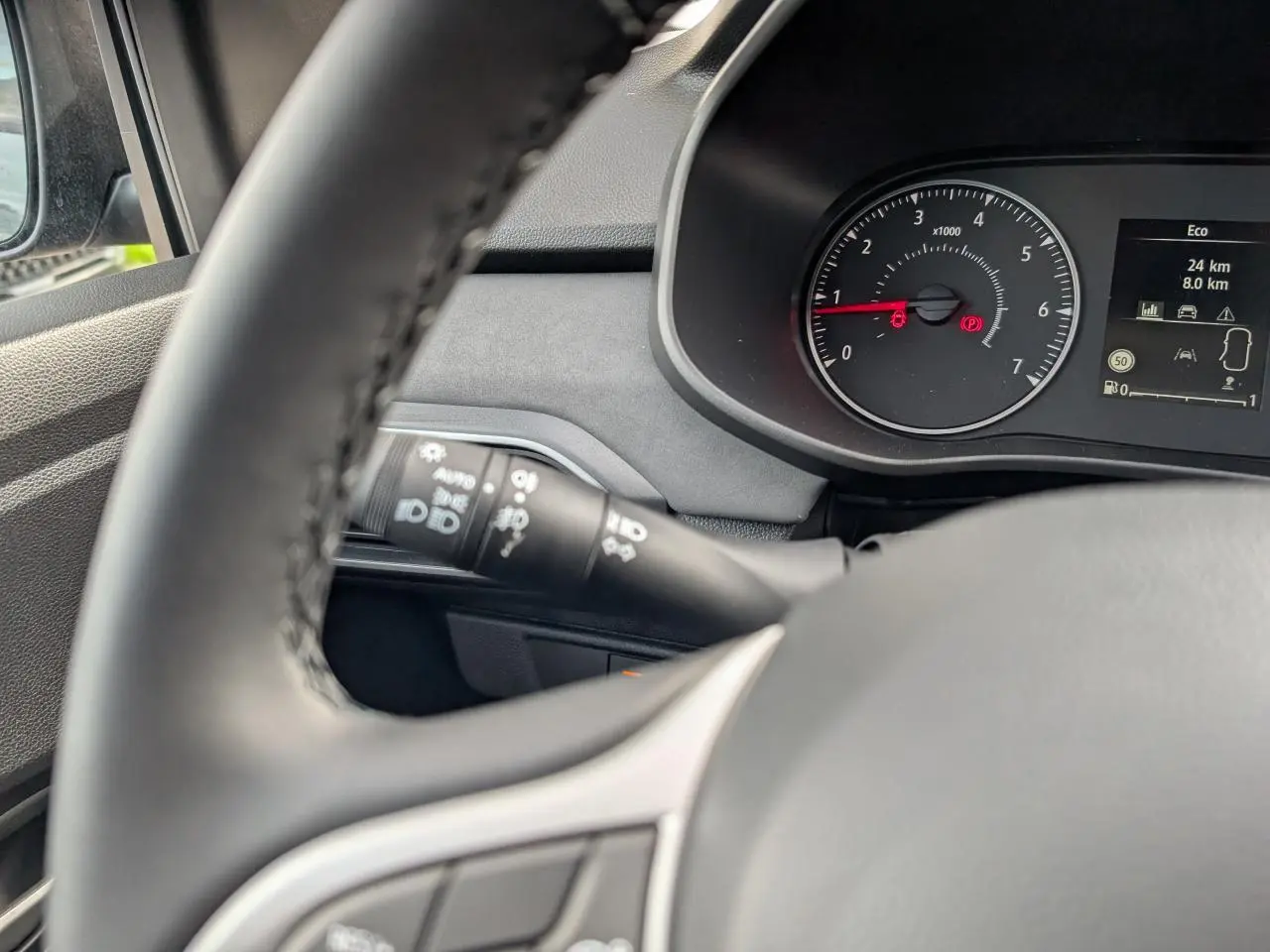 Vue rapprochée du tableau de bord et volant gris acier du Dacia Jogger 2025, avec compte-tours et commandes visibles.