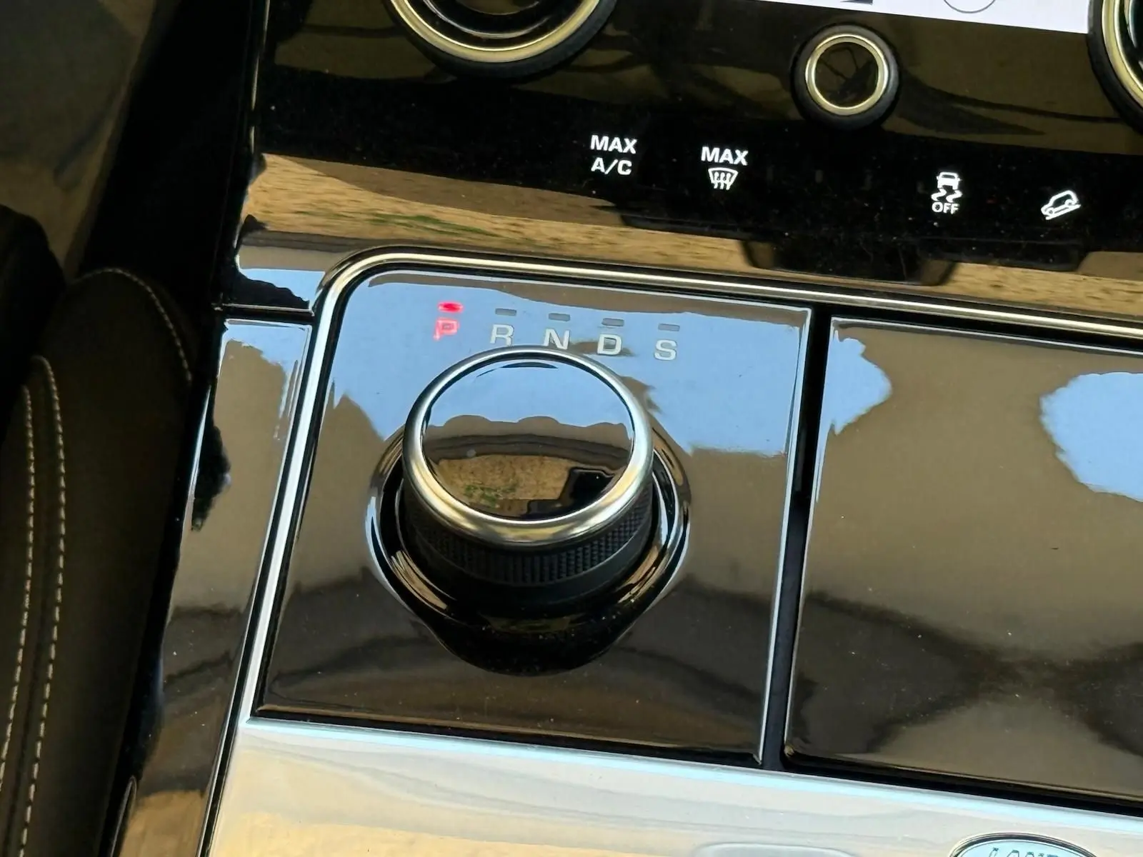 Gros plan sur la molette de sélection de la boîte automatique du Range Rover Velar gris, avec indicateurs lumineux P, R, N, D, S.
