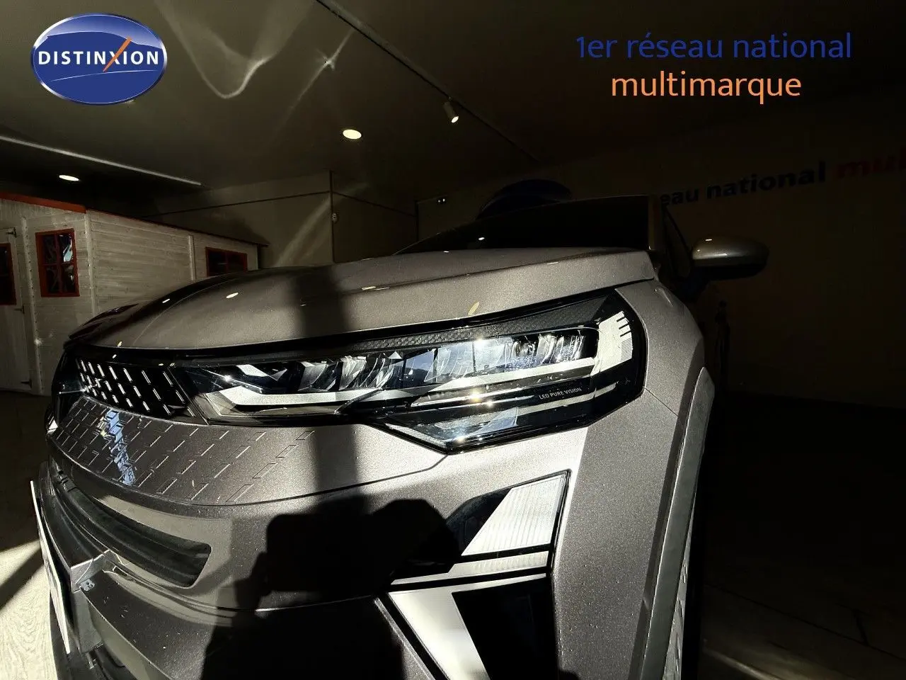 Gros plan sur l'avant droit du Renault Captur gris Cassiopée métal, mettant en valeur son phare LED moderne.