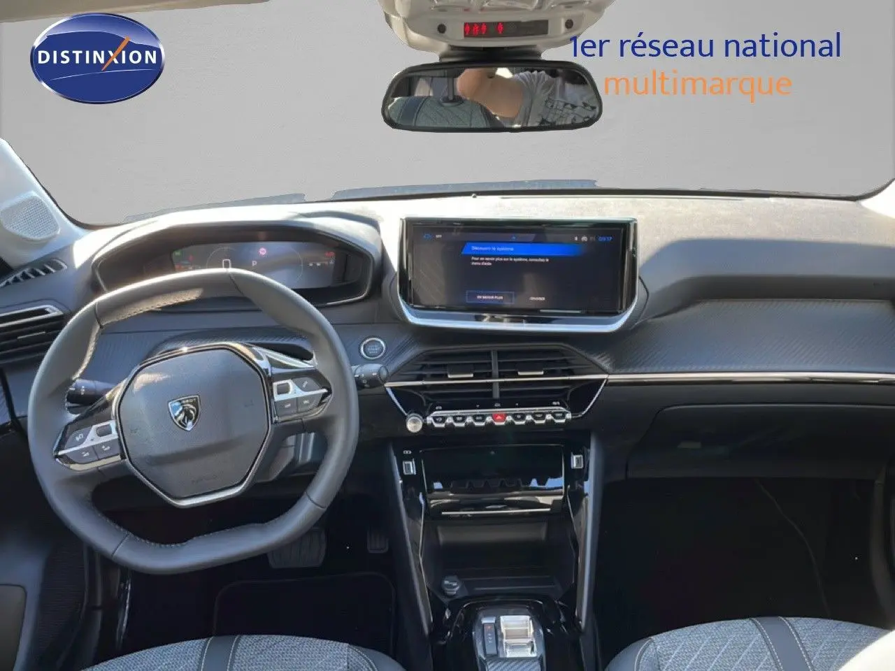 Vue intérieure frontale du tableau de bord et volant de la Peugeot 208 Hybrid 110ch Allure noir perla metal, avec écran tactile et finitions modernes.