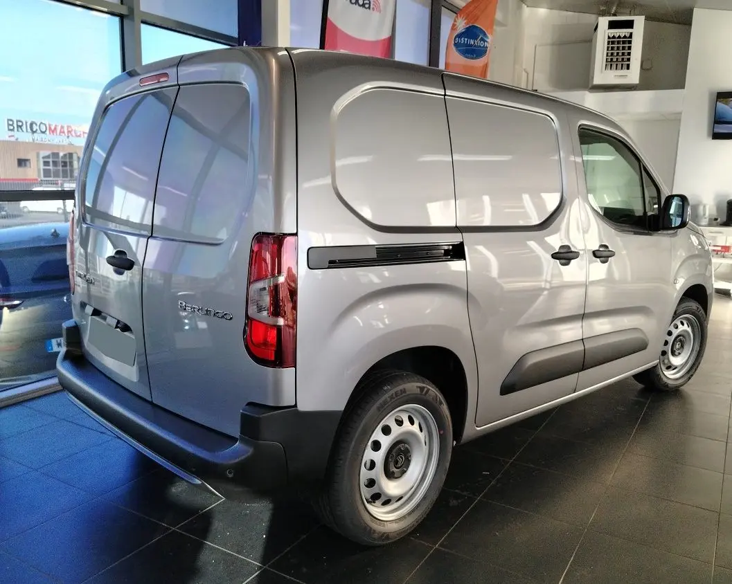 Vue 3/4 arrière droite d'un Citroën Berlingo Van gris acier 2025 avec portes arrière battantes et jantes acier simples.