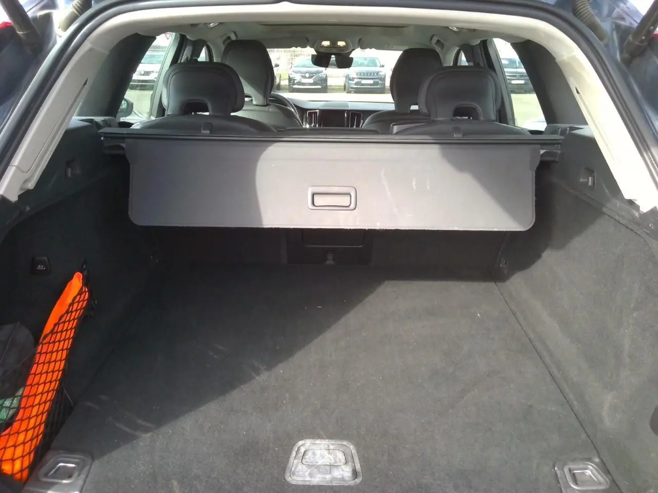 Vue 3/4 arrière droite du Volvo XC60 bleu 2023 avec feux arrière LED et jantes alliage 20 pouces noir diamant.