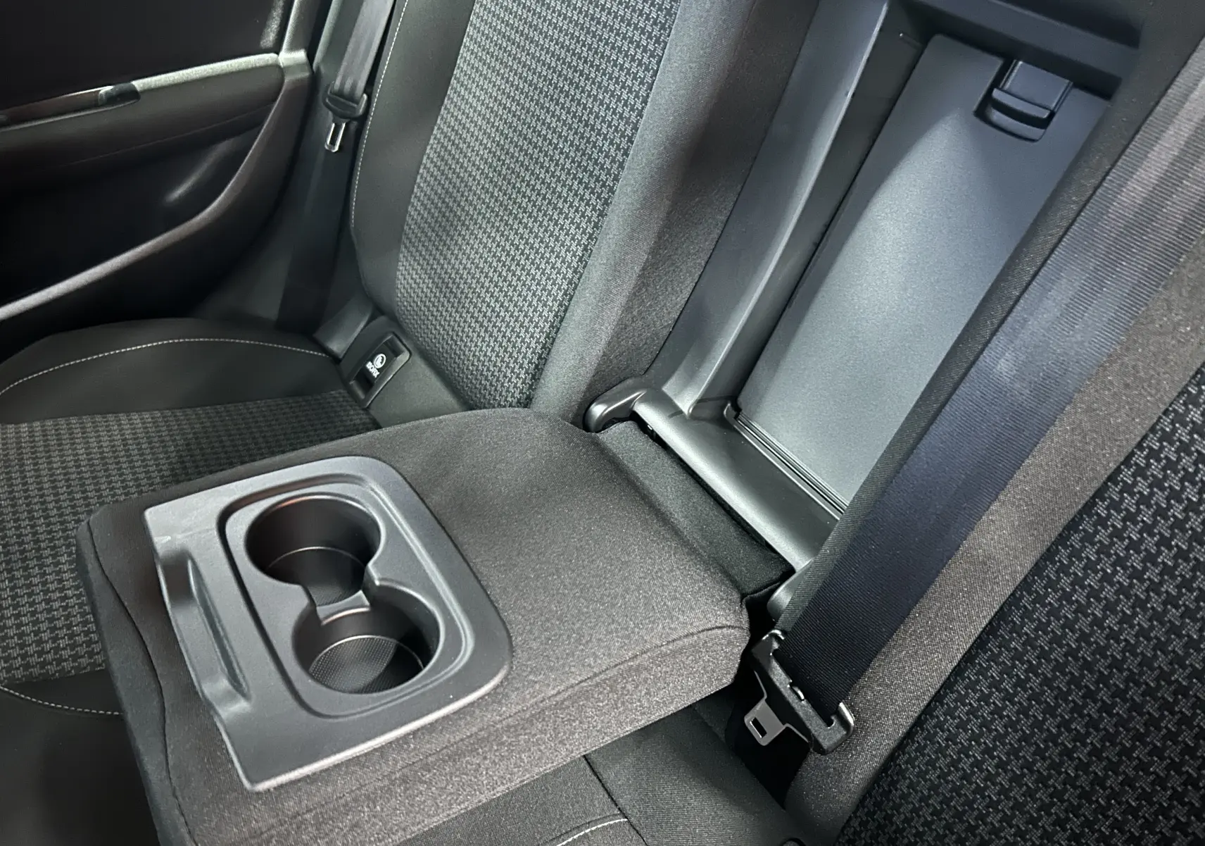 Gros plan sur l'accoudoir central arrière gris avec porte-gobelets dans l'habitacle d'une Peugeot 308 Active Pack 2021.