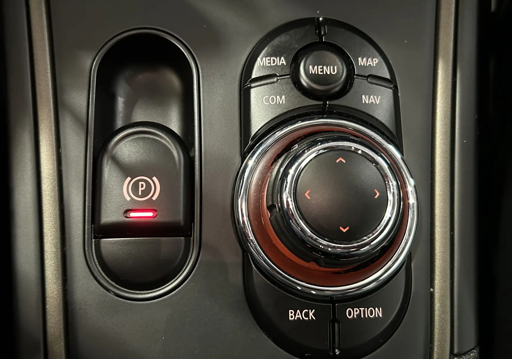 Gros plan sur la molette de commande centrale et le frein à main électrique du MINI Countryman 2021.
