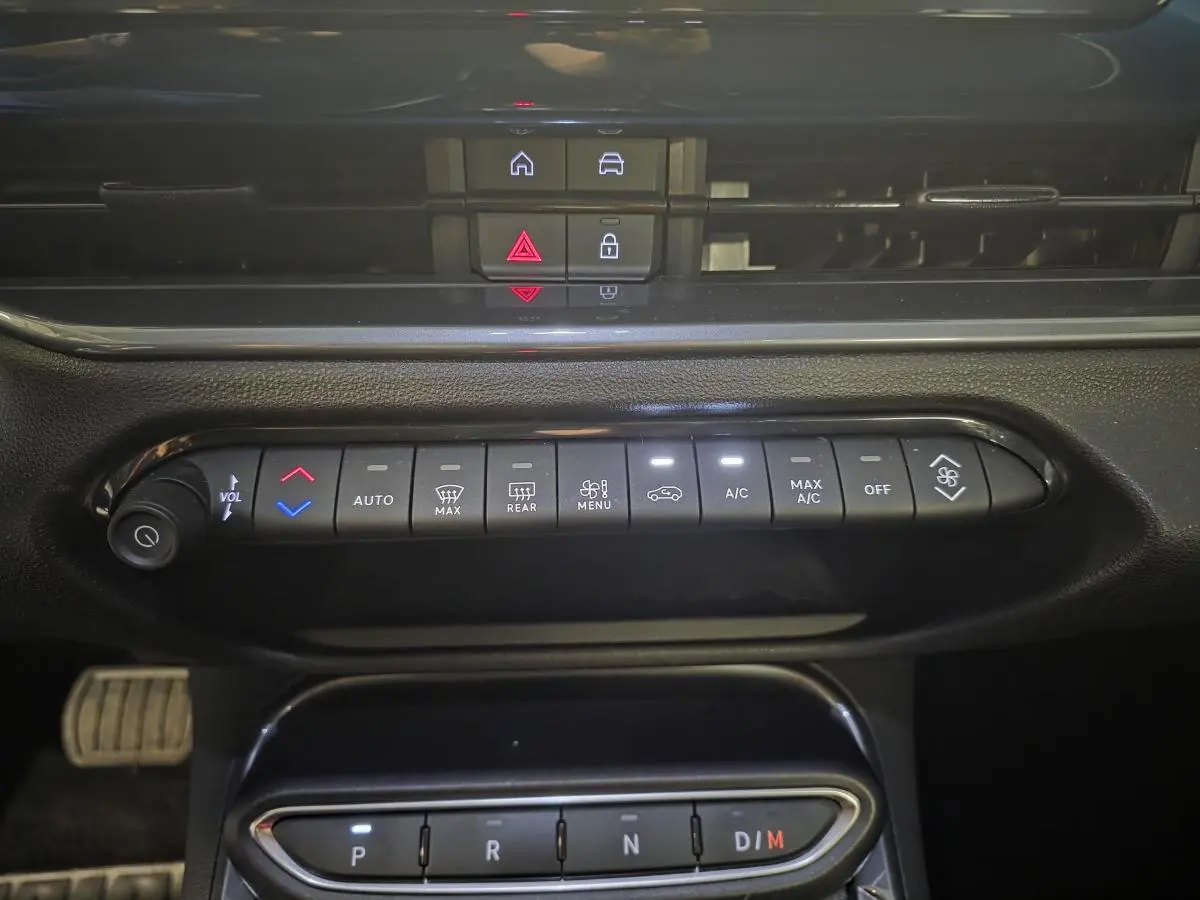 Vue rapprochée du tableau de bord de la Fiat 600 Hybrid 2025, montrant les commandes climatisation et boîte automatique.