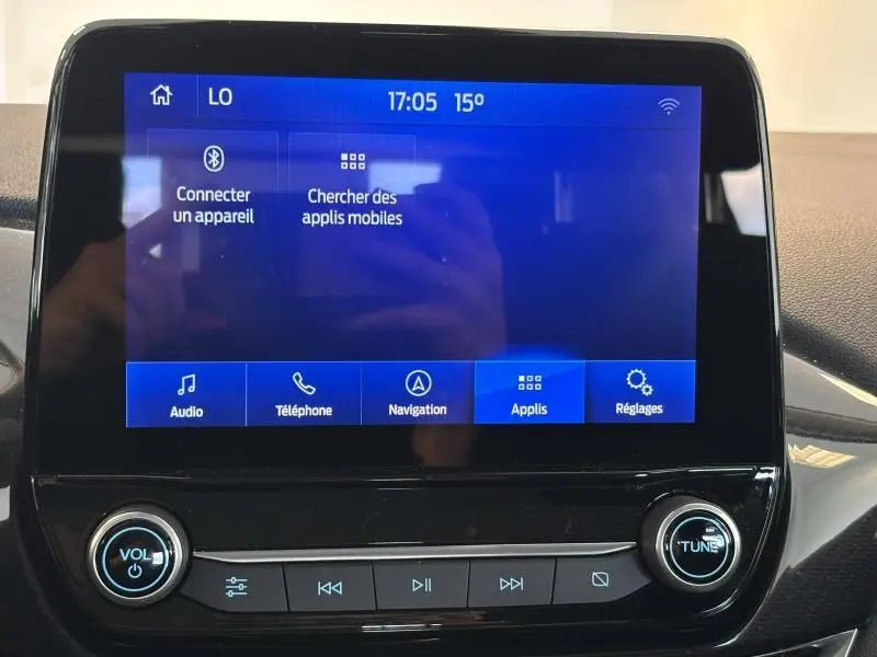 Écran tactile central bleu de la Ford Fiesta 2022, affichant les options audio, téléphone, navigation et réglages.