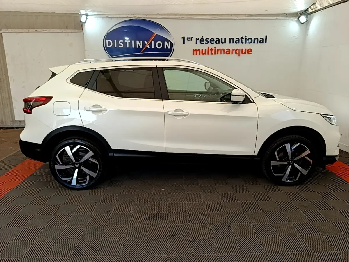 Vue latérale droite d'un Nissan Qashqai blanc 2019 avec jantes alliage noires et toit ouvrant panoramique.