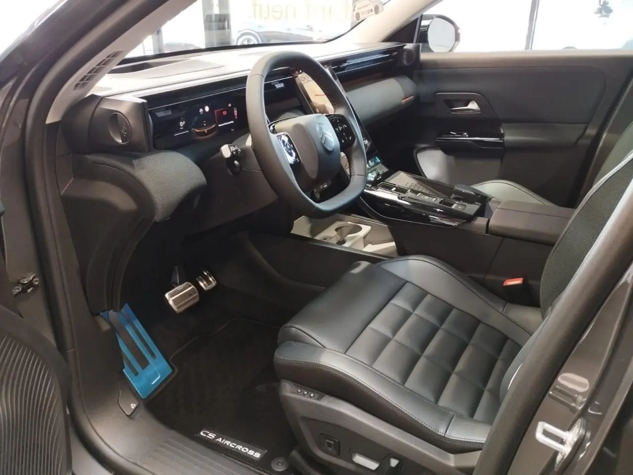 Vue intérieure côté conducteur du Citroën C5 Aircross gris platine, avec sièges cuir noir et tableau de bord moderne.