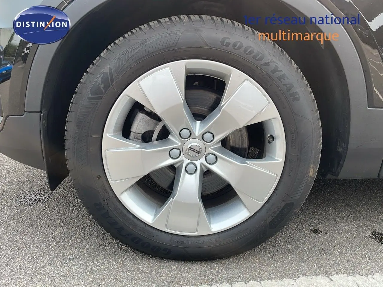 Gros plan sur la roue avant droite du Volvo XC40 noir Onyx Metal avec jante argentée et pneu Goodyear.
