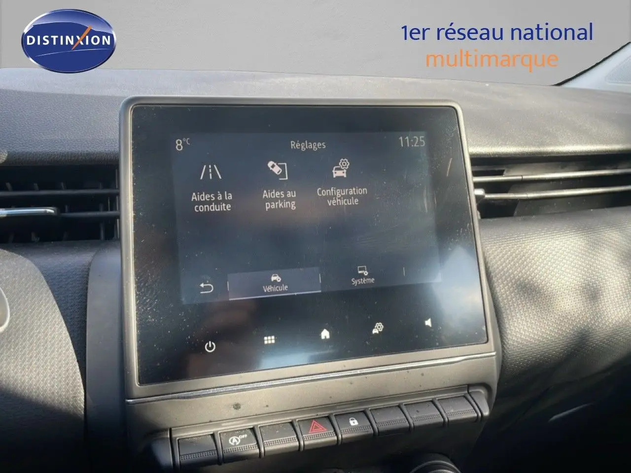 Écran tactile central du tableau de bord de la Renault Clio blanc glacier, affichant les réglages d’aides à la conduite.