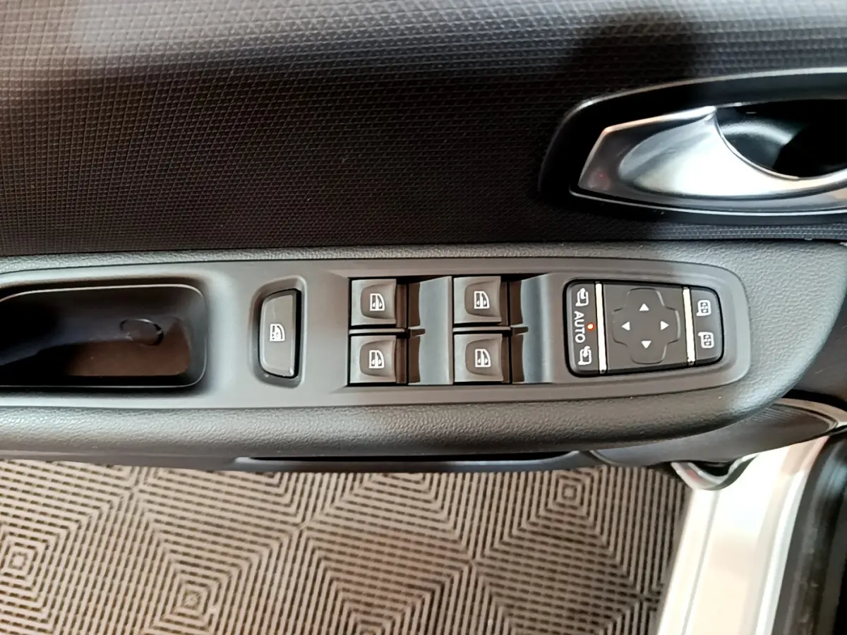 Commande des vitres électriques et réglages des rétroviseurs sur la porte côté conducteur d'une Renault Clio Business gris clair 2019.