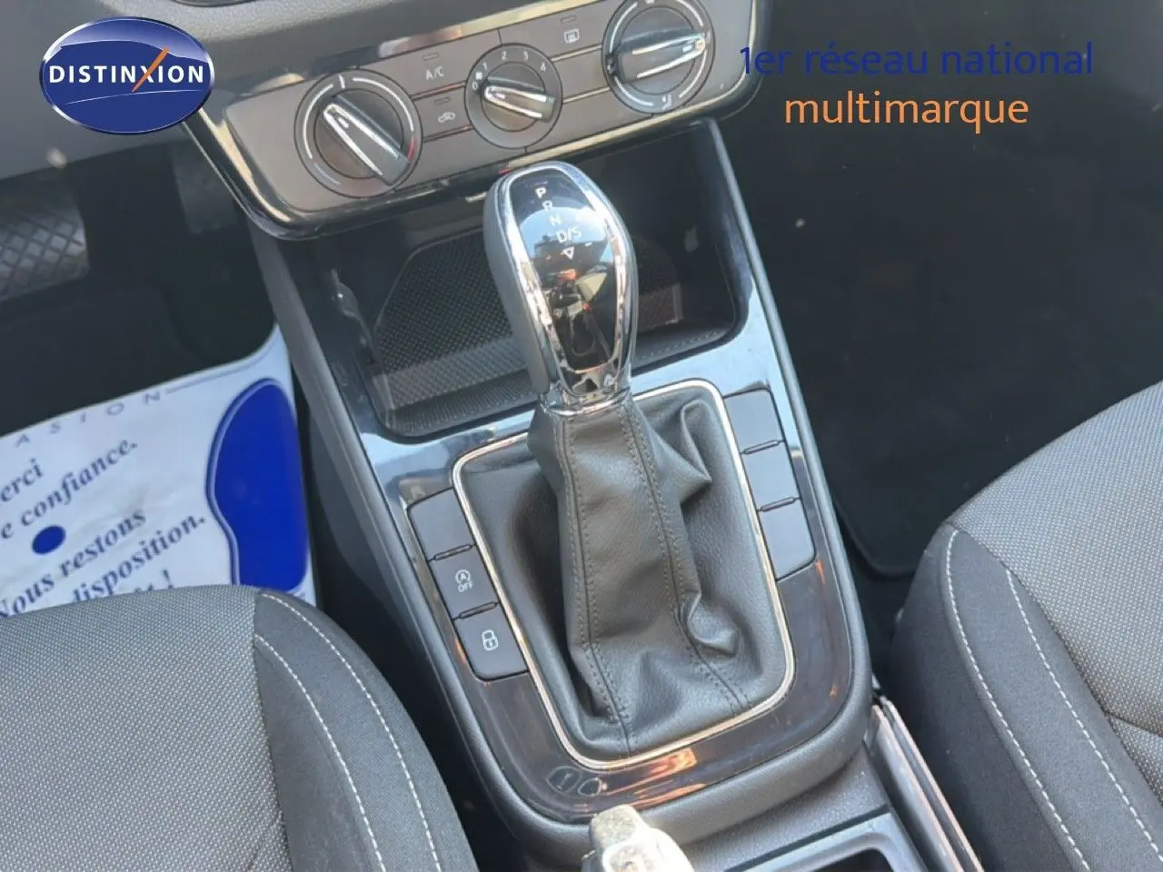 Gros plan sur la console centrale de la Skoda Fabia 2025, boîte automatique avec levier en cuir et commandes climatisation.
