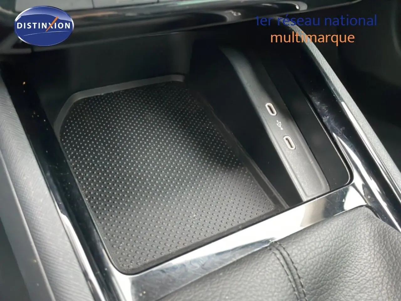 Détail de la console centrale noire du Skoda Kamiq 2025 avec zone de recharge sans fil et ports USB visibles.