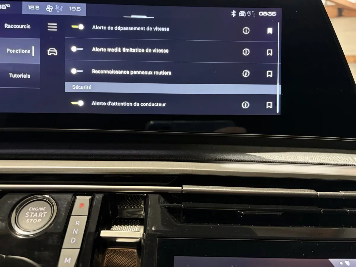 Vue rapprochée du tableau de bord du Peugeot 3008 blanc, mettant en valeur l'écran tactile et le bouton démarrage.