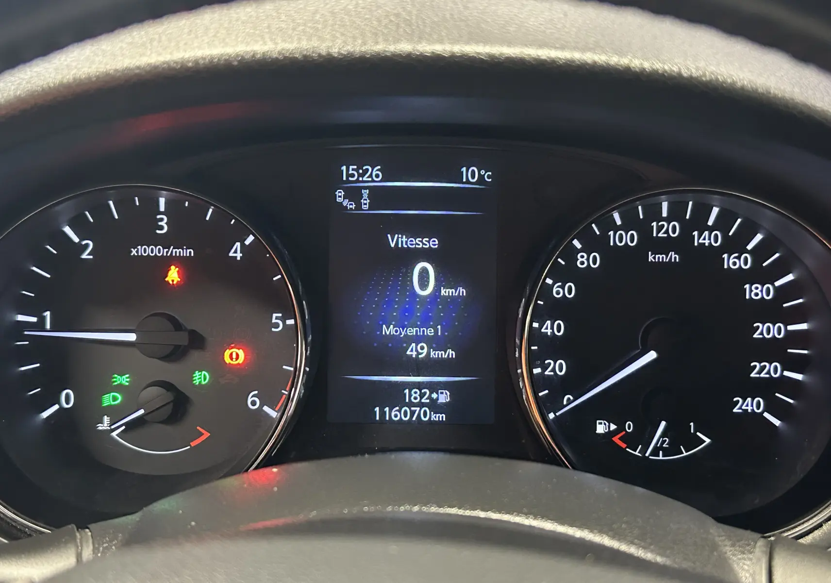 Vue rapprochée du tableau de bord de la Nissan Pulsar gris, affichant vitesse à 0 km/h et compte-tours.