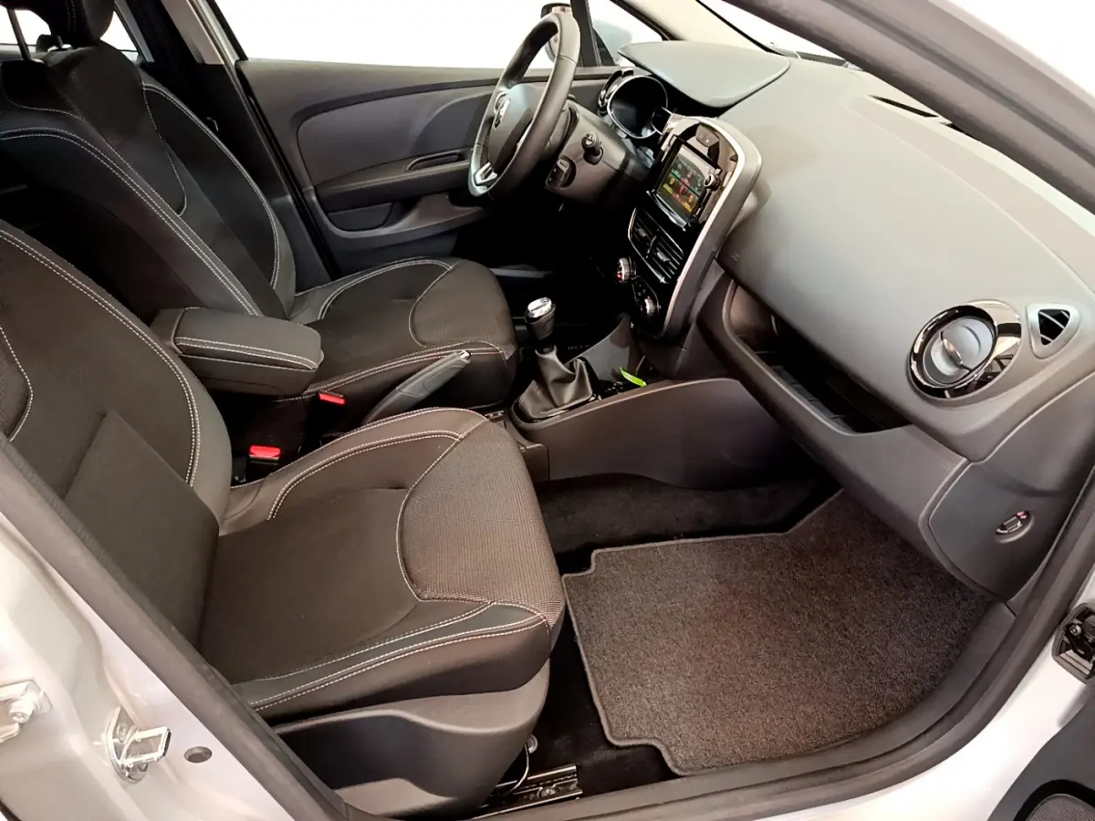 Vue intérieure côté conducteur de la Renault Clio Business TCe 90 2019, sièges noirs et tableau de bord avec écran tactile.