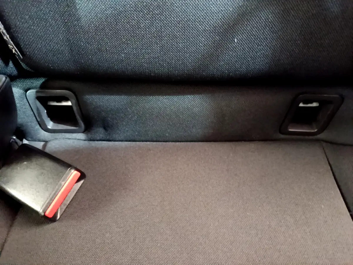 Gros plan sur la banquette arrière noire de la Renault Clio Business TCe 90, montrant la ceinture de sécurité et les fixations Isofix.