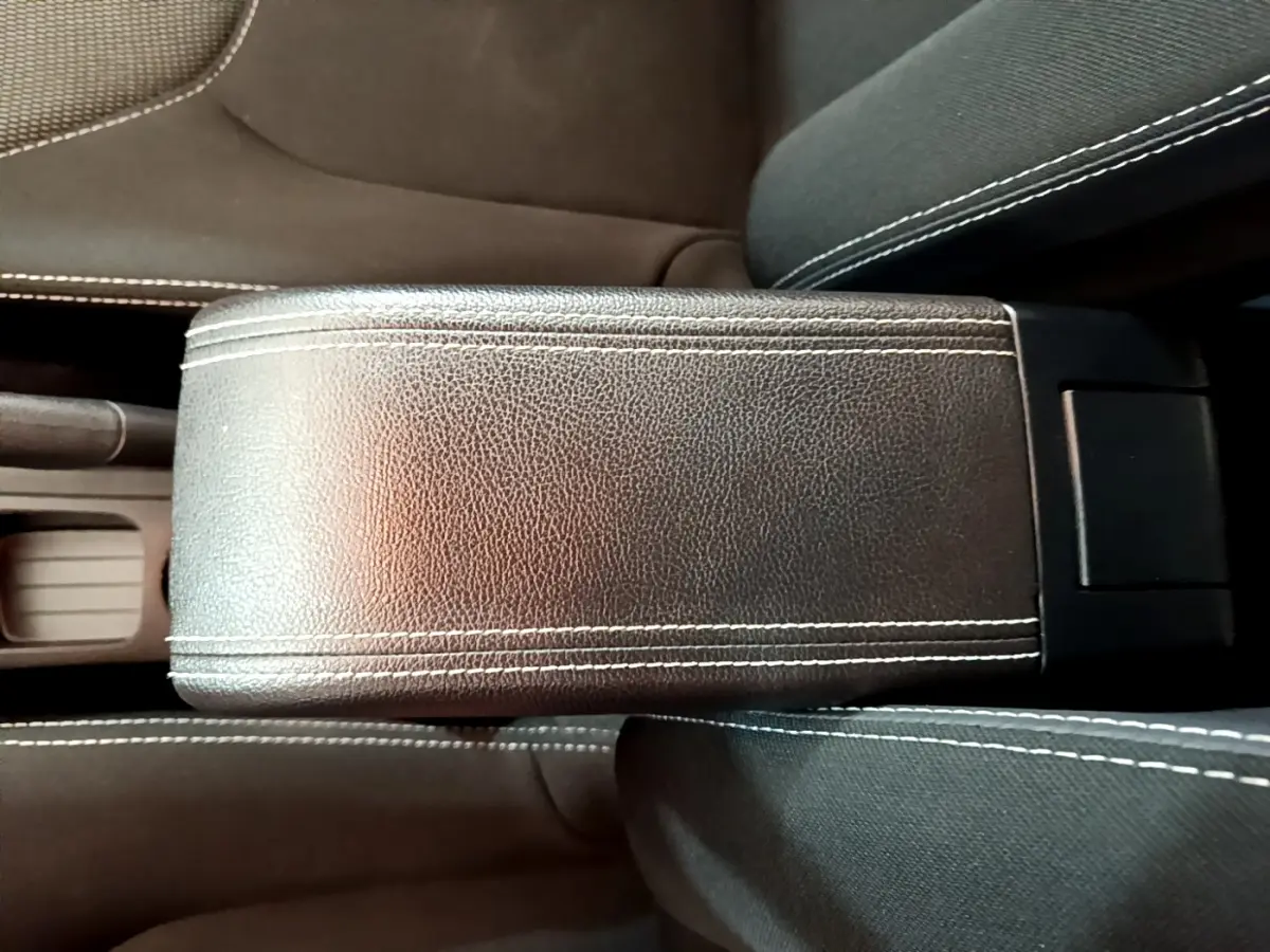 Accoudoir central en cuir noir avec surpiqûres blanches dans l'habitacle d'une Renault Clio Business TCe 90 2019.