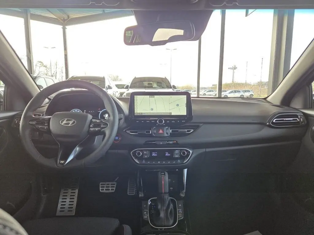 Vue intérieure avant du tableau de bord de la Hyundai i30 SW N-LINE 2025 avec écran tactile et volant multifonction noir.