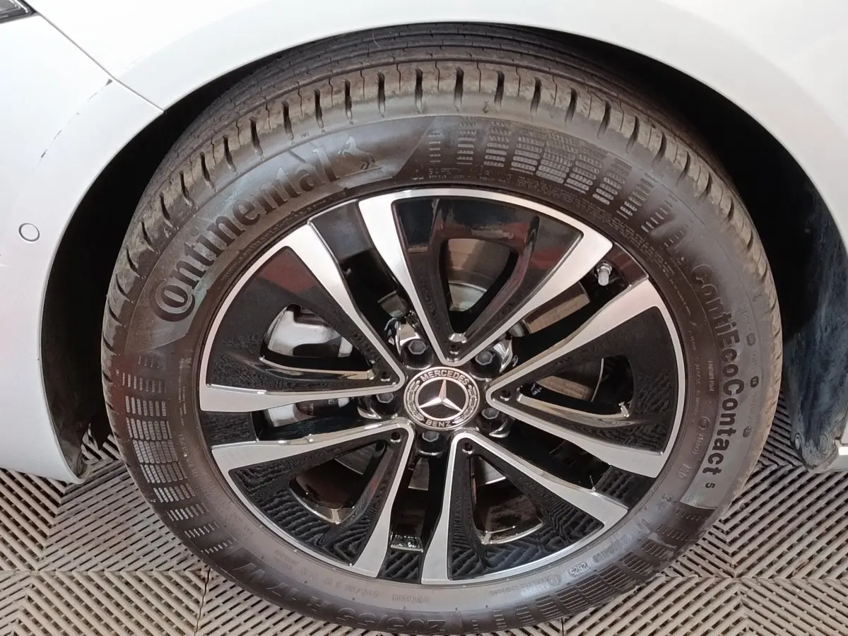 Gros plan sur la roue avant gauche d’une Mercedes GLA 250 e Business Line gris foncé avec jante alliage noir et argent.