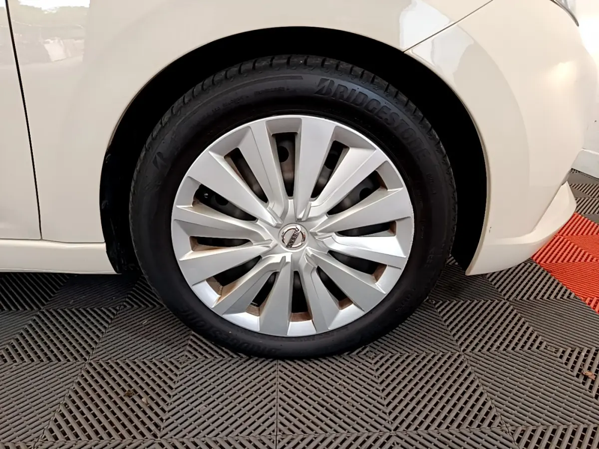 Gros plan sur la roue avant gauche blanche d'une Nissan Micra IG-T 92 Acenta 2022 avec jante en alliage argenté.