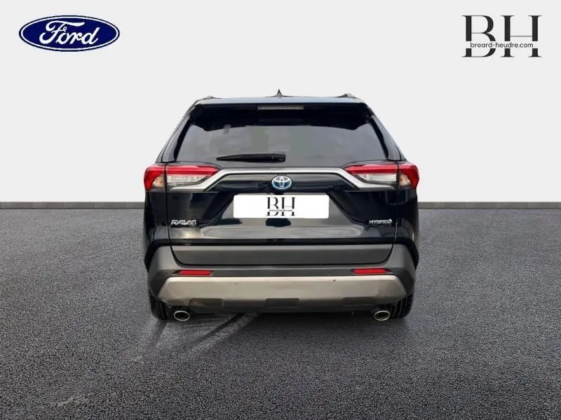 Vue arrière d'un Toyota RAV4 noir métallisé, mettant en valeur ses feux LED et double sortie d'échappement.