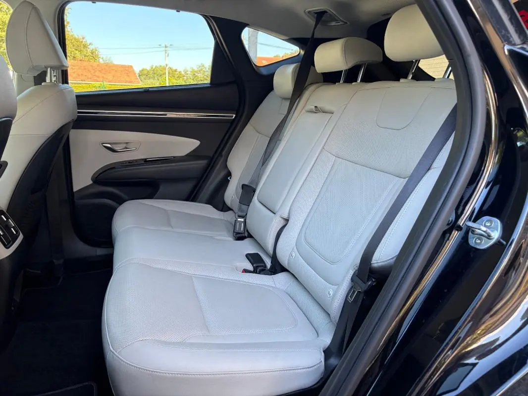 Vue côté droit de la banquette arrière claire du Hyundai Tucson noir 2022, avec ceinture de sécurité et porte ouverte.