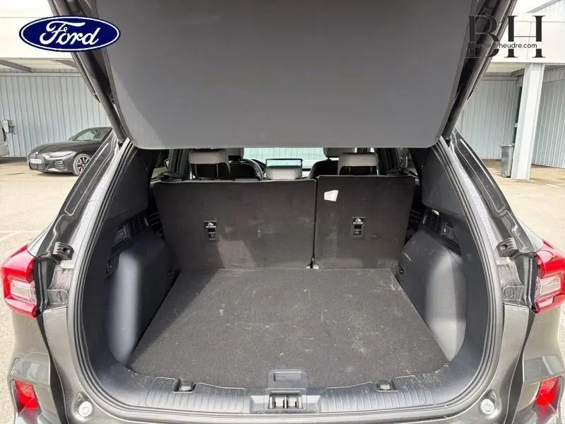 Coffre ouvert vue arrière du Ford Kuga gris Magnetic Fashion Métallisée avec banquette arrière en tissu noir.