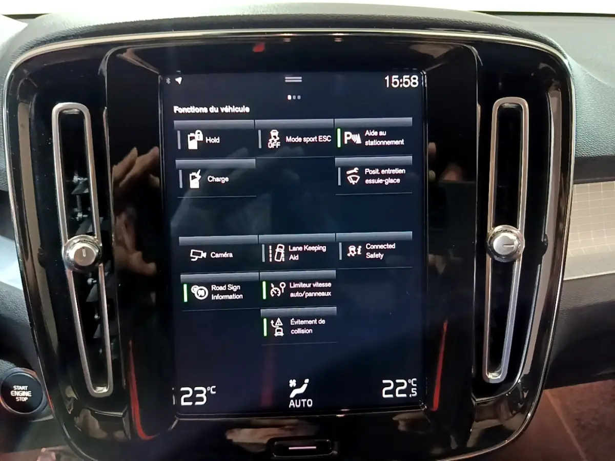 Vue rapprochée de l'écran tactile central noir du tableau de bord du Volvo XC40 Recharge T4 Business 2020 affichant les fonctions du véhicule.